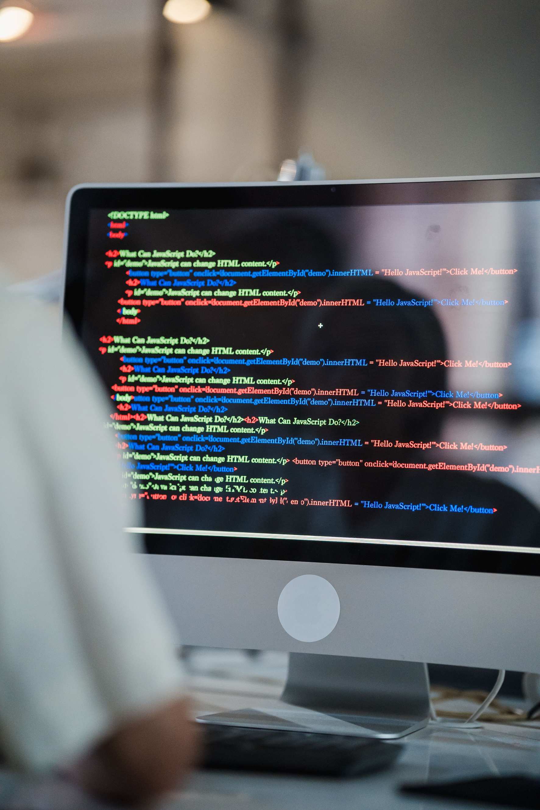 Developer workspace with colorful coding script on screen in office environment