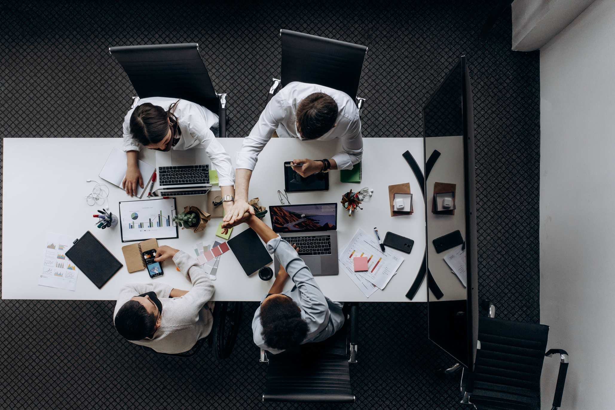 Office workspace used for technical planning with colleagues around conference table in modern office